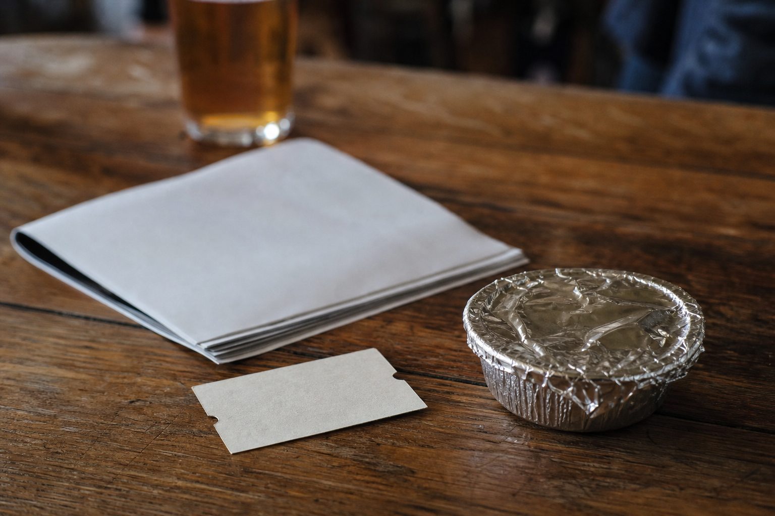 A blank train ticket, a programme and a pie on a pub table (picture made with AI)